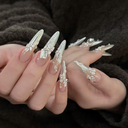 Completed spring manicure design featuring raised white floral charms created with the silicone stencil.