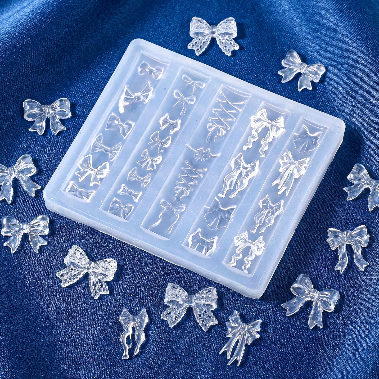 Finished 3D bow embellishments created using the Thrymme silicone carving stencil on press-on nails.