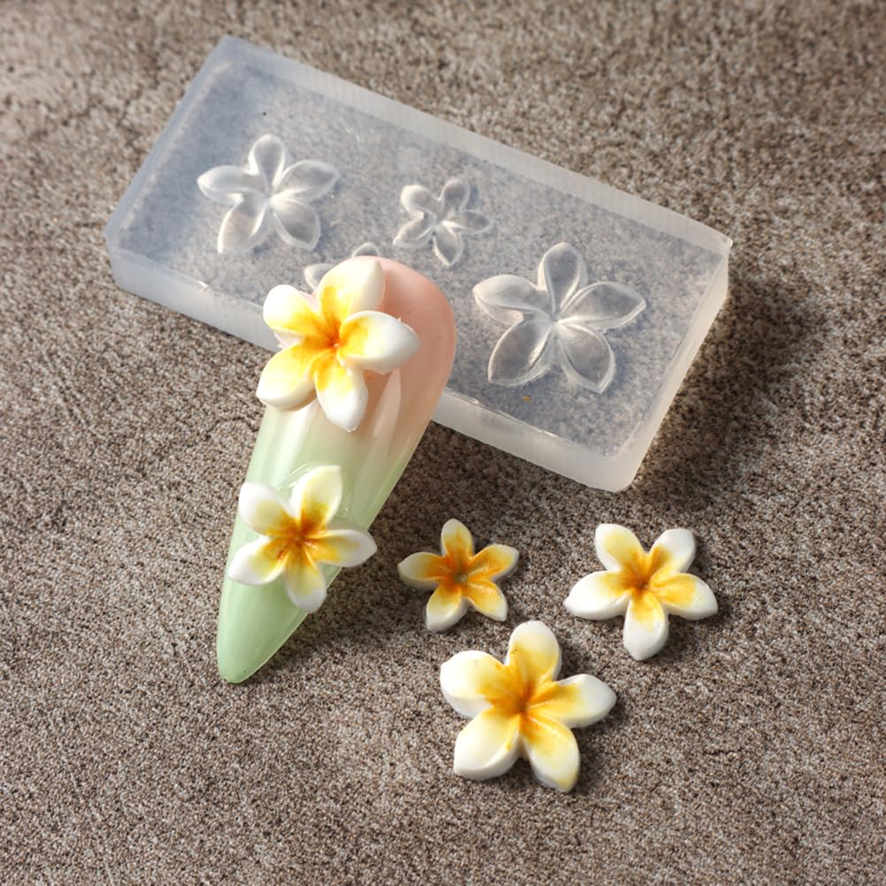 Four rectangular transparent flower molds arranged neatly alongside a finished 3D manicure