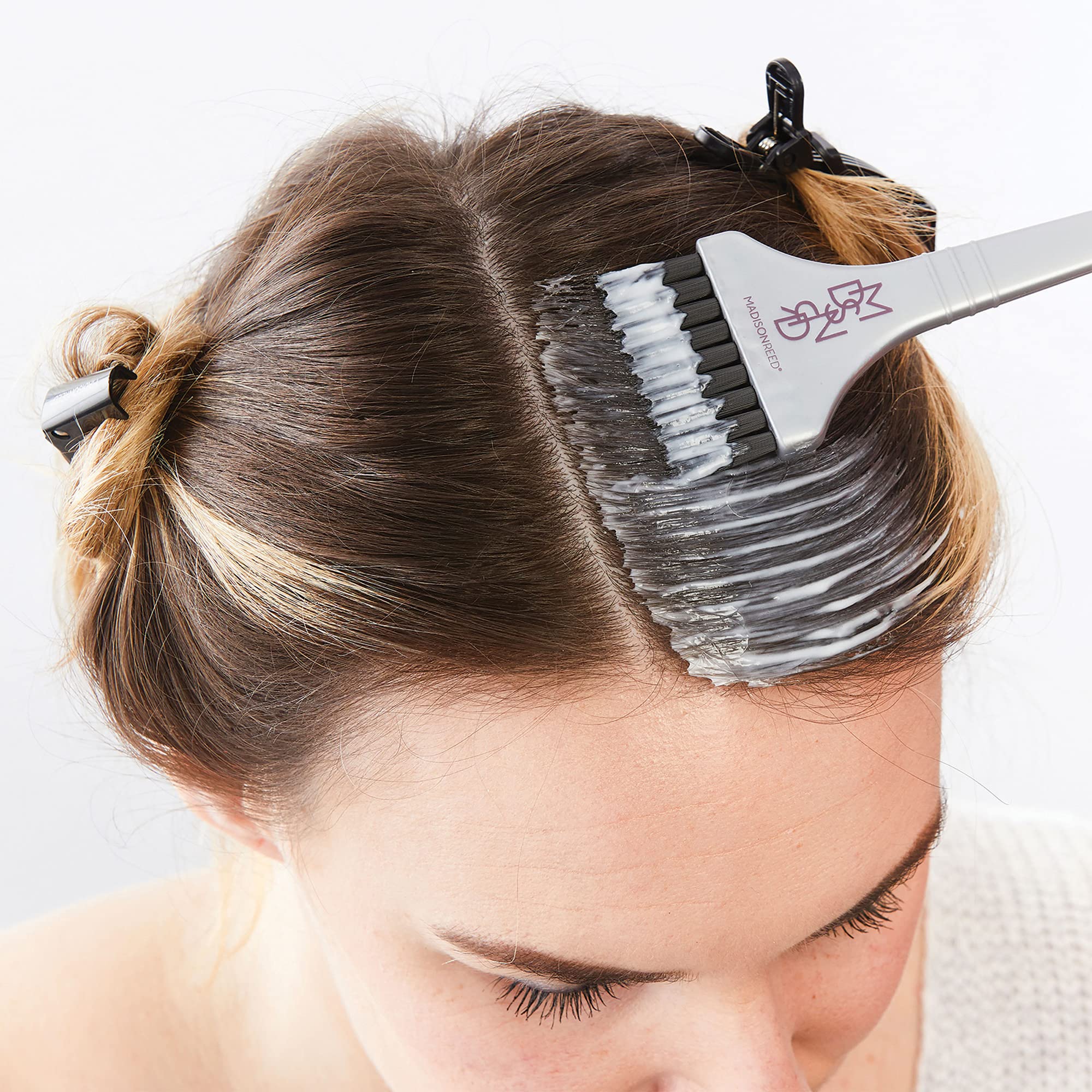 Close up view of the Madison Reed reusable non metallic mixing bowl and ergonomic hair dye application brush.