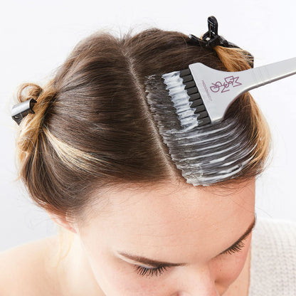 Close up view of the Madison Reed reusable non metallic mixing bowl and ergonomic hair dye application brush.