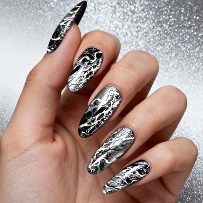 Detailed view of the precise etching on the abstract marble vein nail transfer plates.