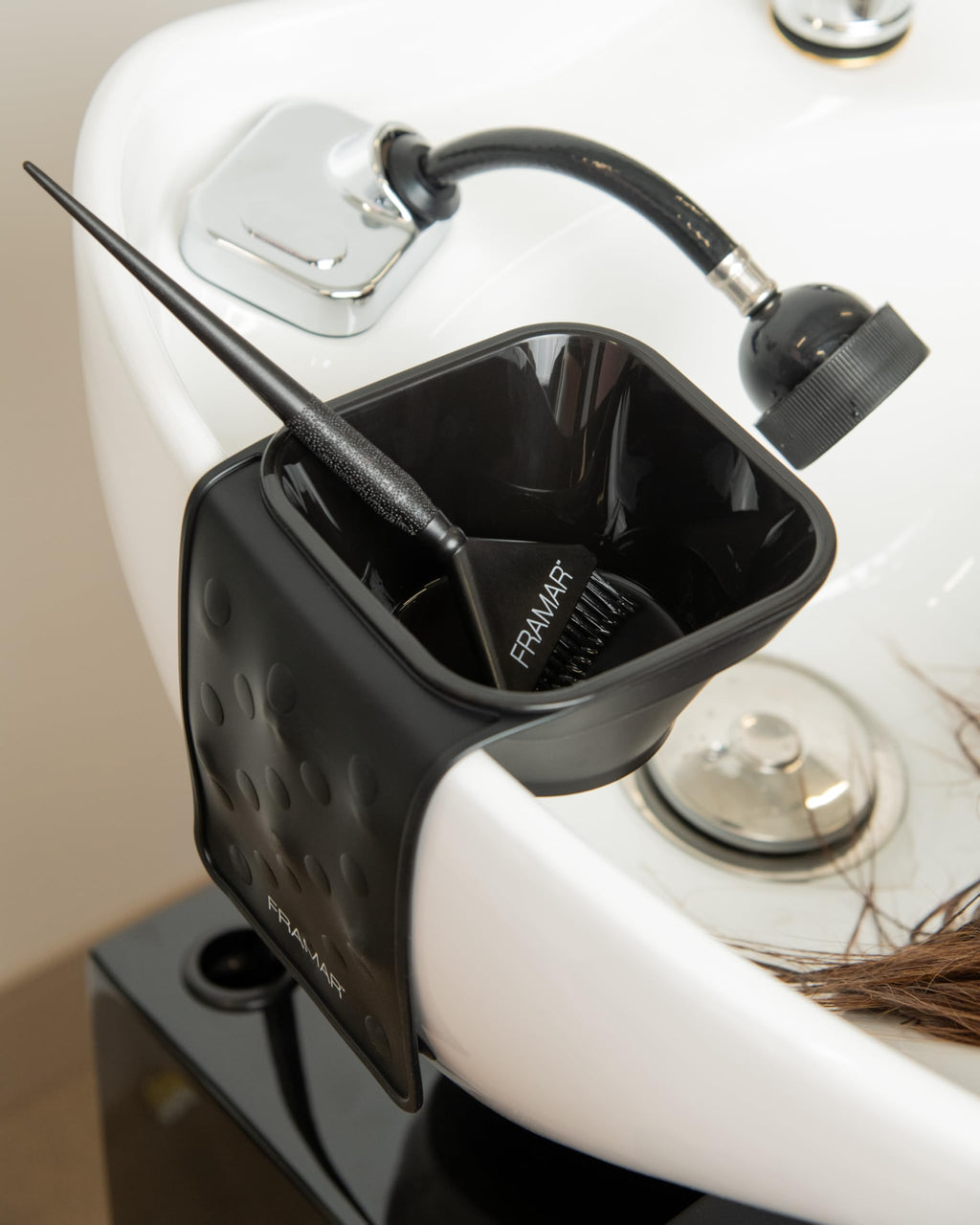 Hairstylist utilizing the imported FRAMAR hair dye bowl system during a professional salon toning service.
