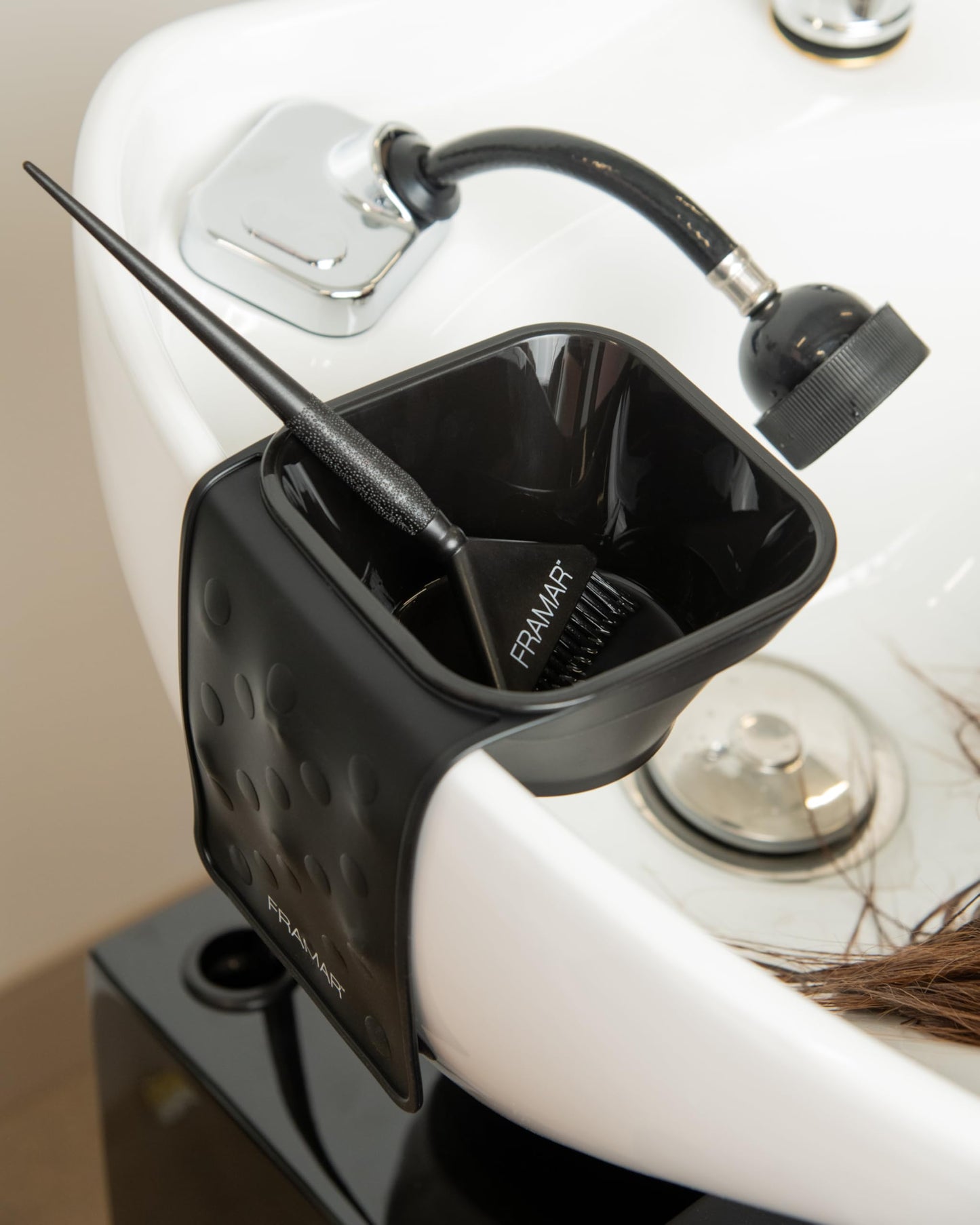 Hairstylist utilizing the imported FRAMAR hair dye bowl system during a professional salon toning service.