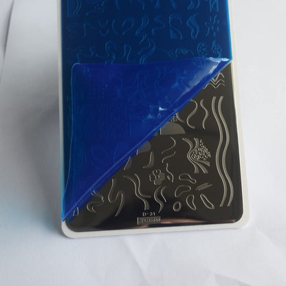 Close up of French tip nail stamp designs on metal plate