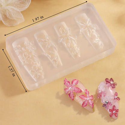 Detailed view of cherry blossom plumeria and hibiscus patterns on a clear silicone mold