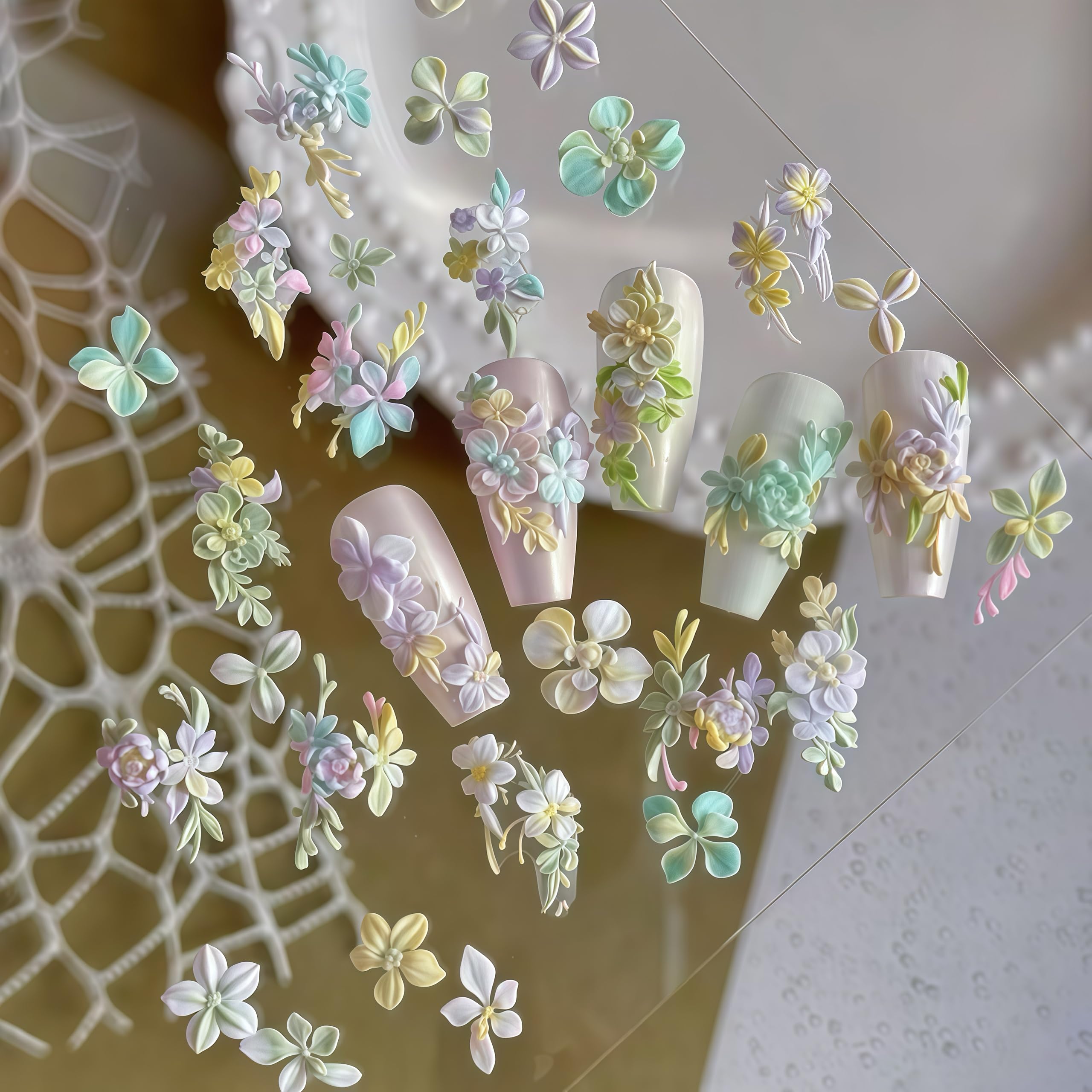 Assorted 3D hibiscus and cherry blossom nail charms created using the Gehaiwo silicone art template