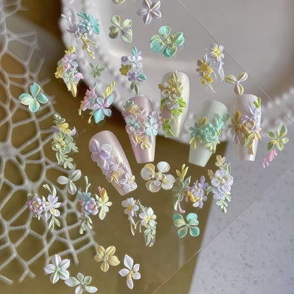 Assorted 3D hibiscus and cherry blossom nail charms created using the Gehaiwo silicone art template