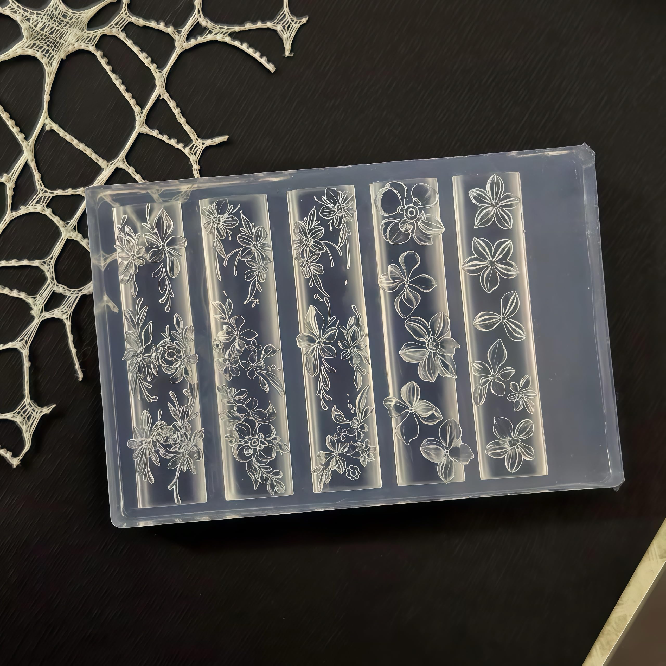 Gehaiwo silicone nail tool alongside finished floral manicure decorations and professional nail supplies