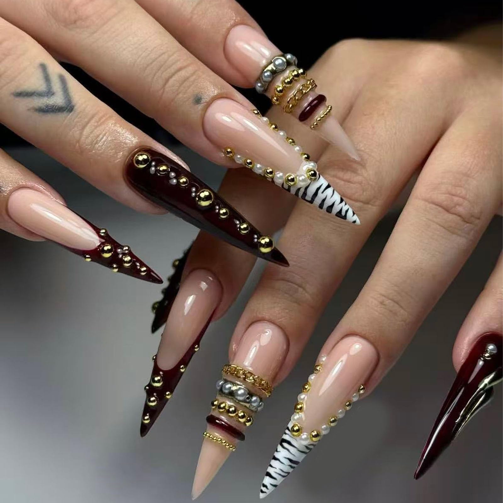 Finished three dimensional chain design applied to a maximalist manicure style.
