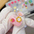 Closer view of the flexible button design resin mold for professional manicures.