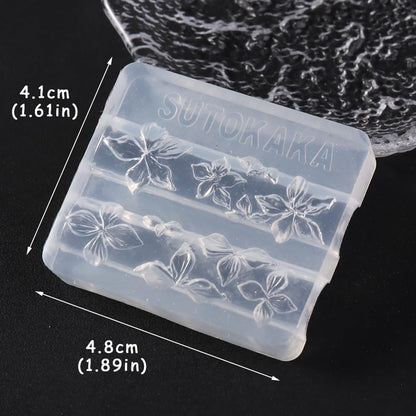Flexible transparent silicone manicure tool being flexed to demonstrate easy demoulding