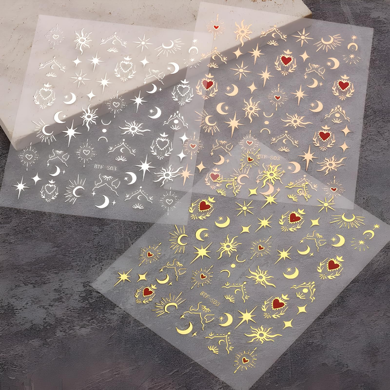 Applying star and moon nail stickers to fingernails