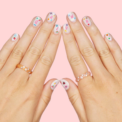 Girl applying Xo, Fetti nail stickers during a DIY party activity