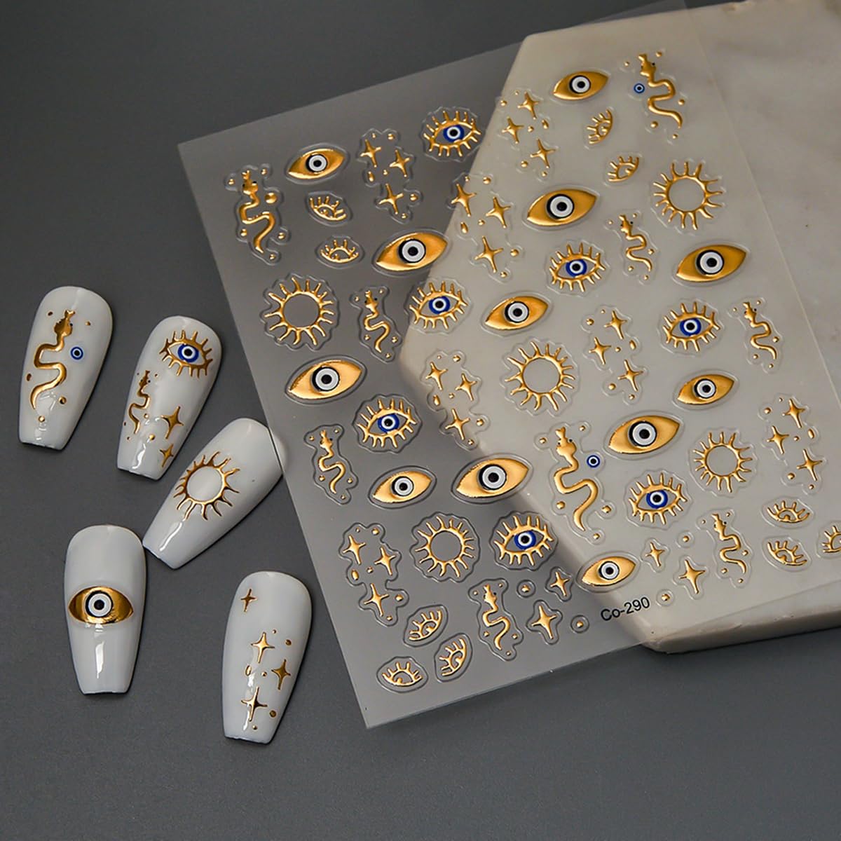 Detailed view of embossed metallic celestial nail designs