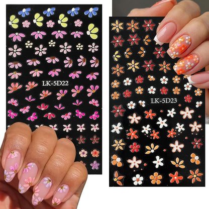 Application of embossed nail stickers using pink tweezers