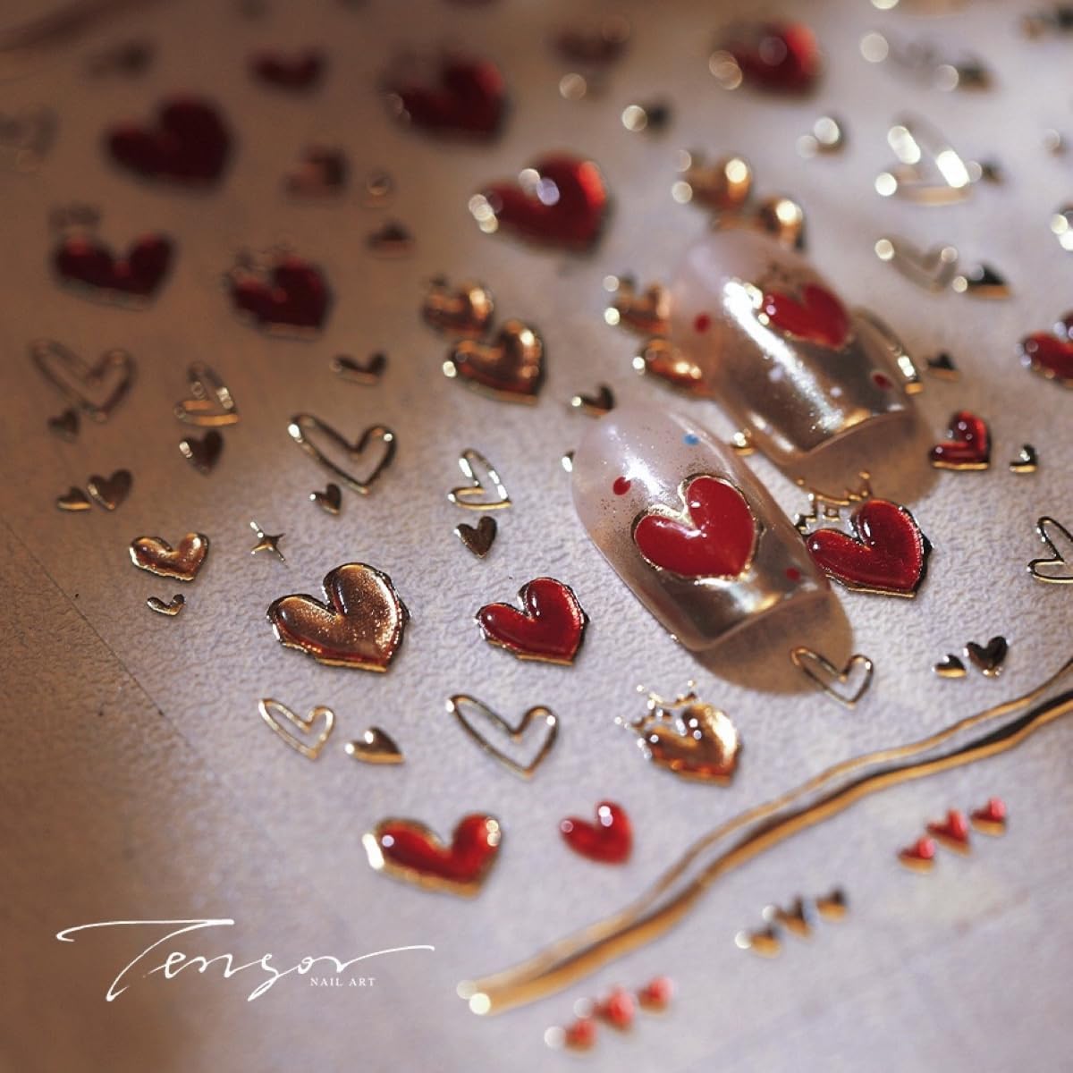 Close up of embossed red heart nail decorations