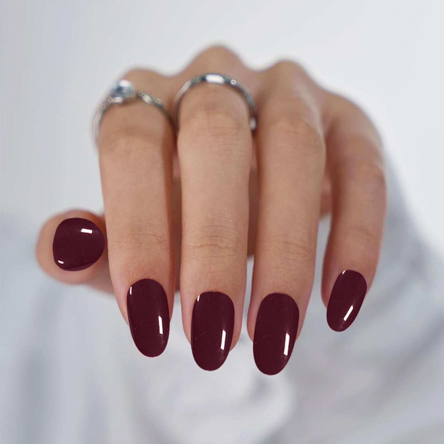 Model showing application of burgundy gel nail wraps
