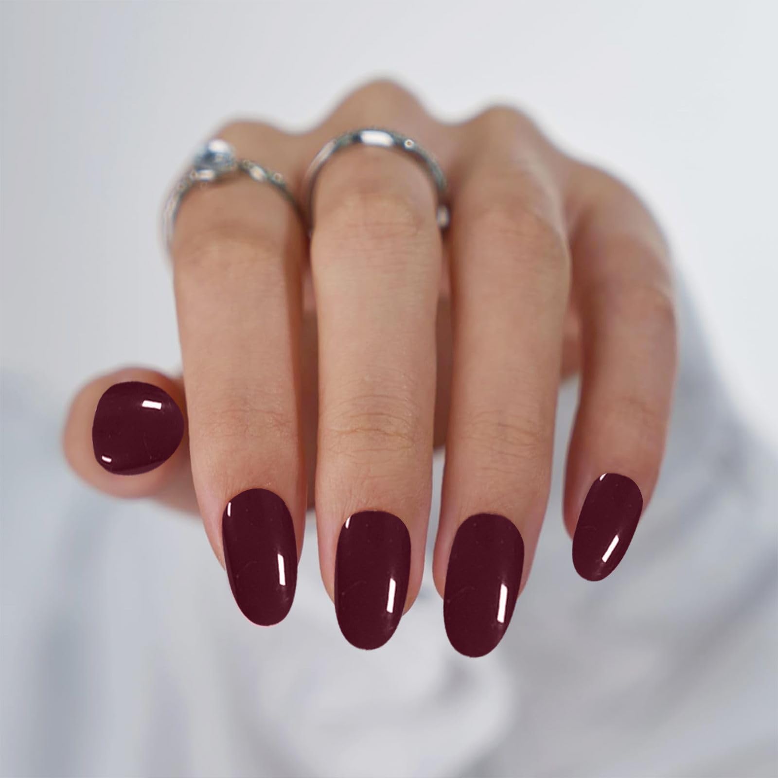 Model showing application of burgundy gel nail wraps