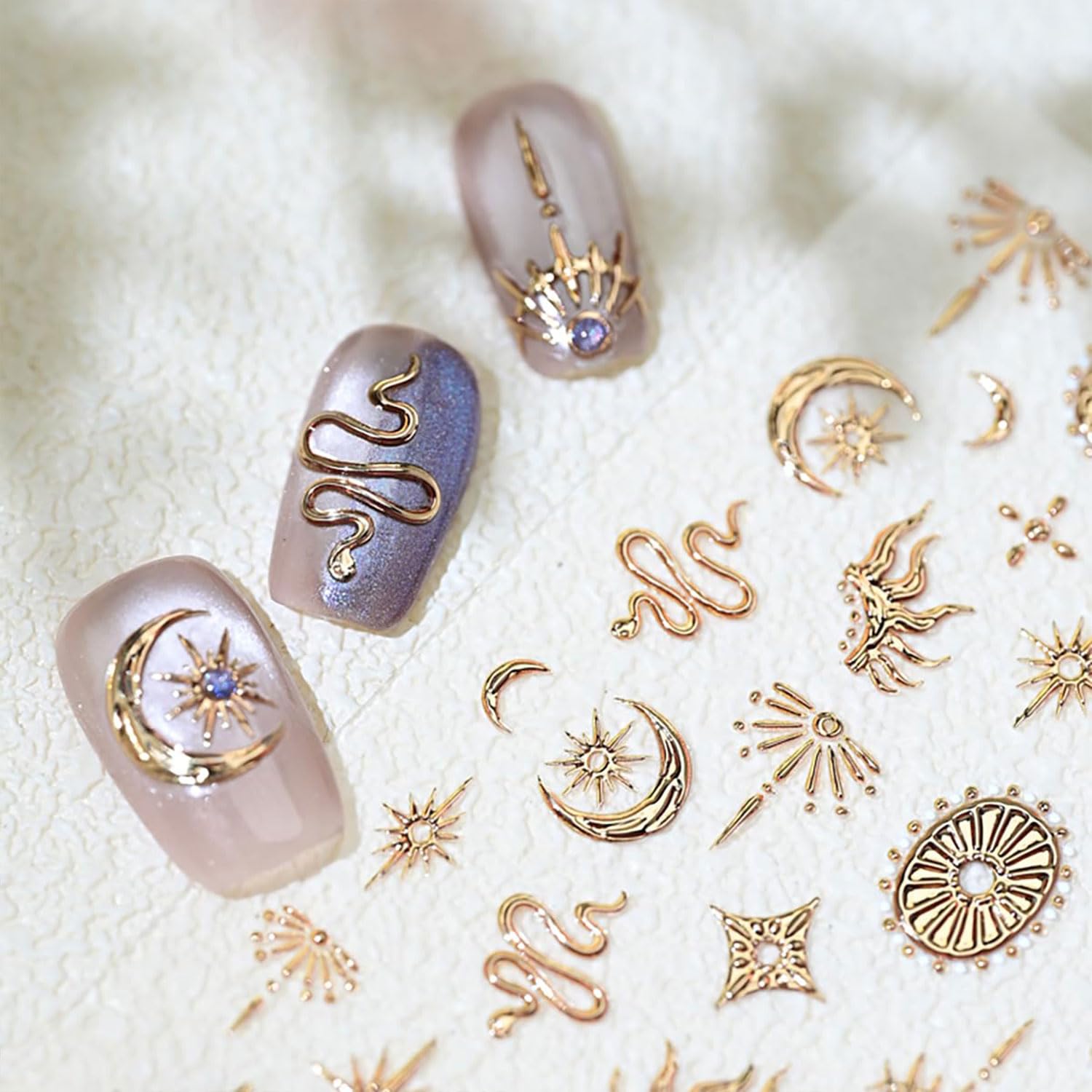 Close up of gold snake and moon nail art decals