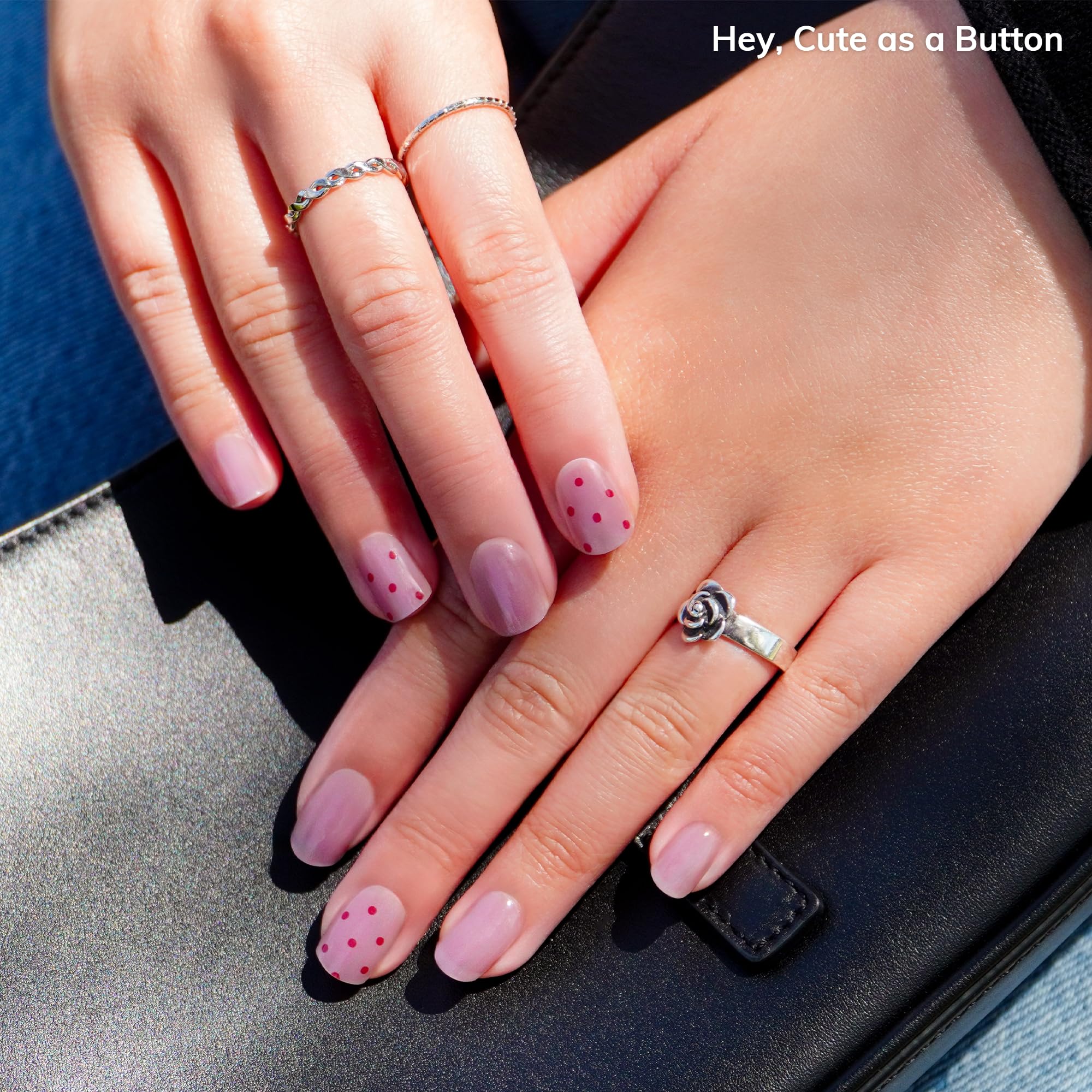 Close up of dusty mauve nail strips with red polka dots design