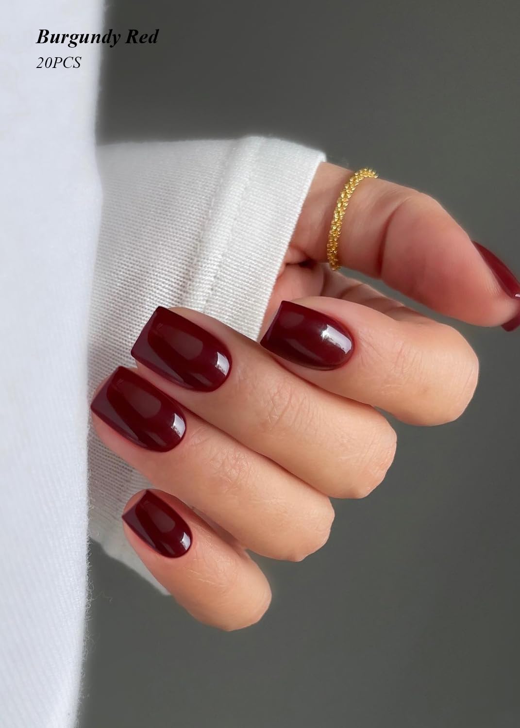 Close up of burgundy gel nail stickers applied to fingers