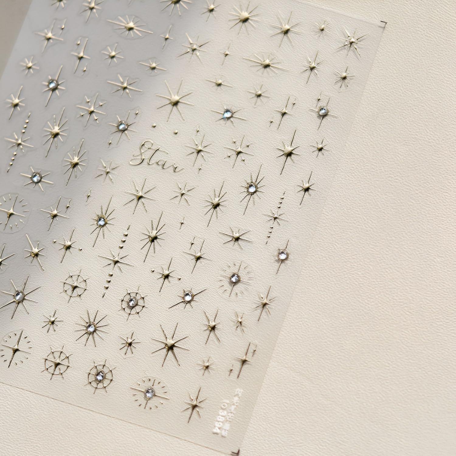 Detailed view of pink gold and white star nail stickers