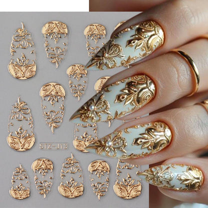 Metallic golden totem nail art sliders on a manicured hand