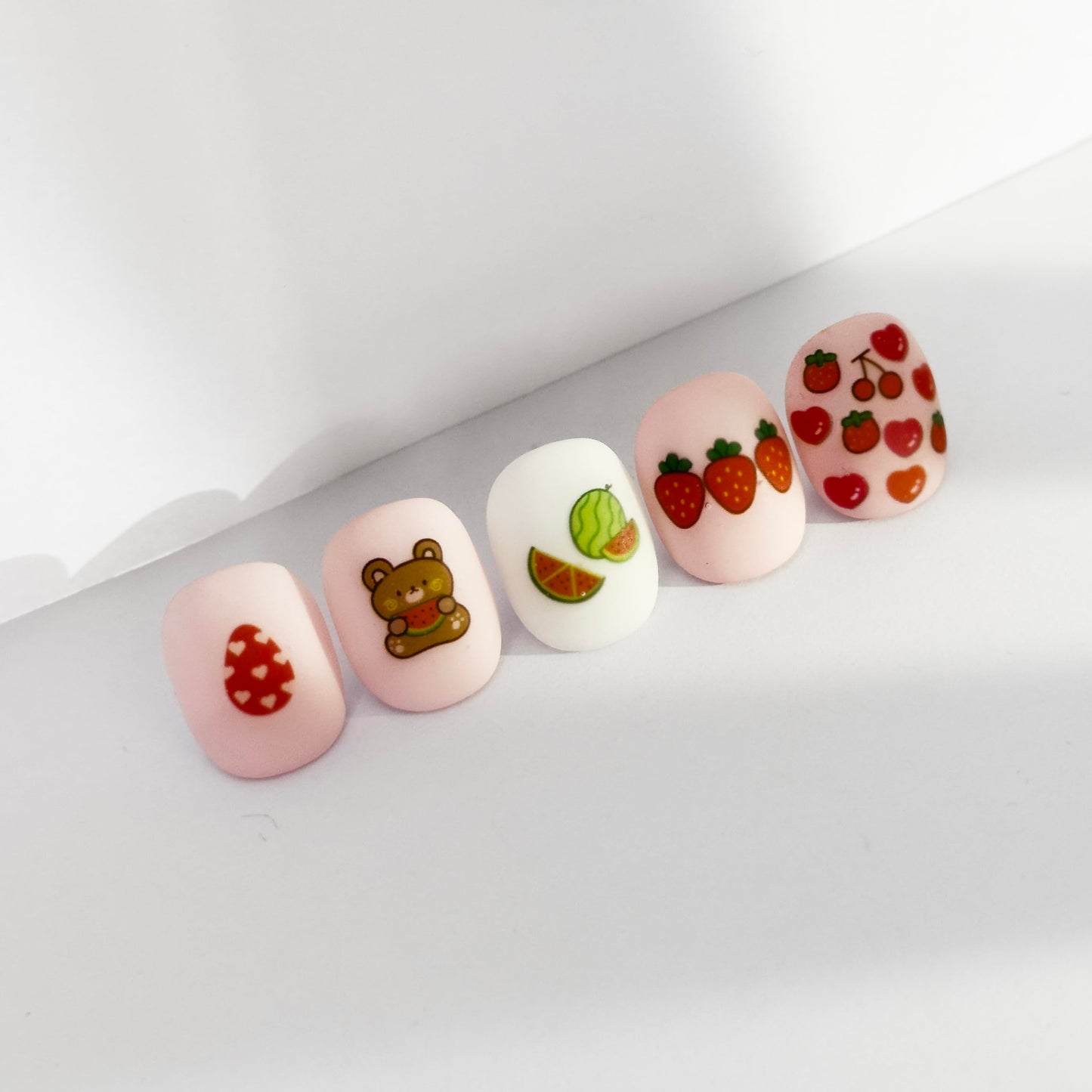 Detailed view of fruit and flower nail art stickers for kids