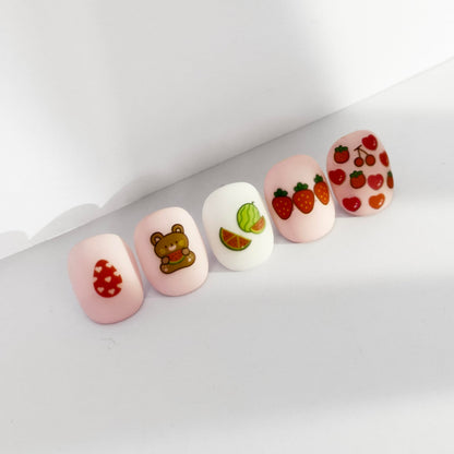 Detailed view of fruit and flower nail art stickers for kids