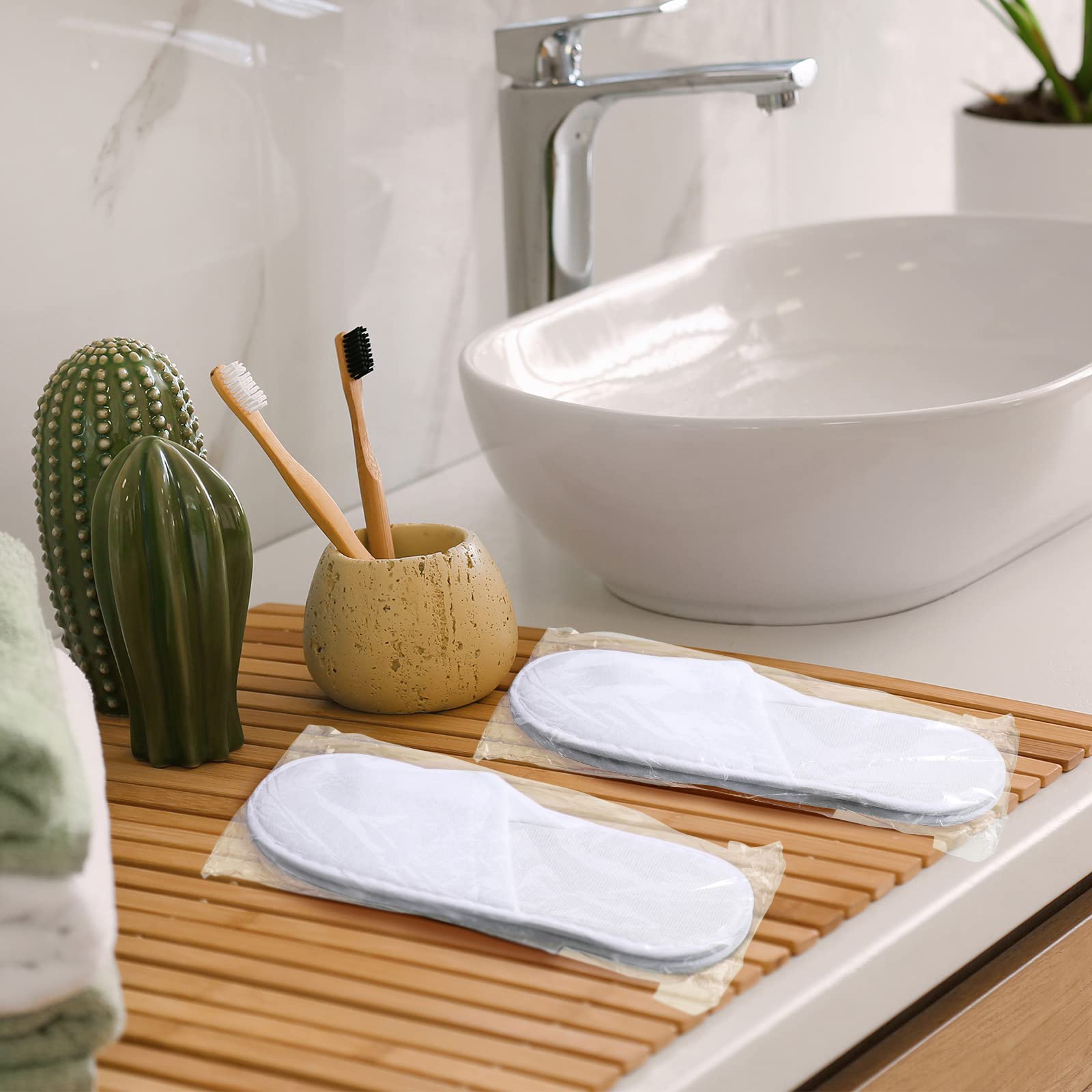 Bulk set of 120 pairs of white hotel guest slippers.