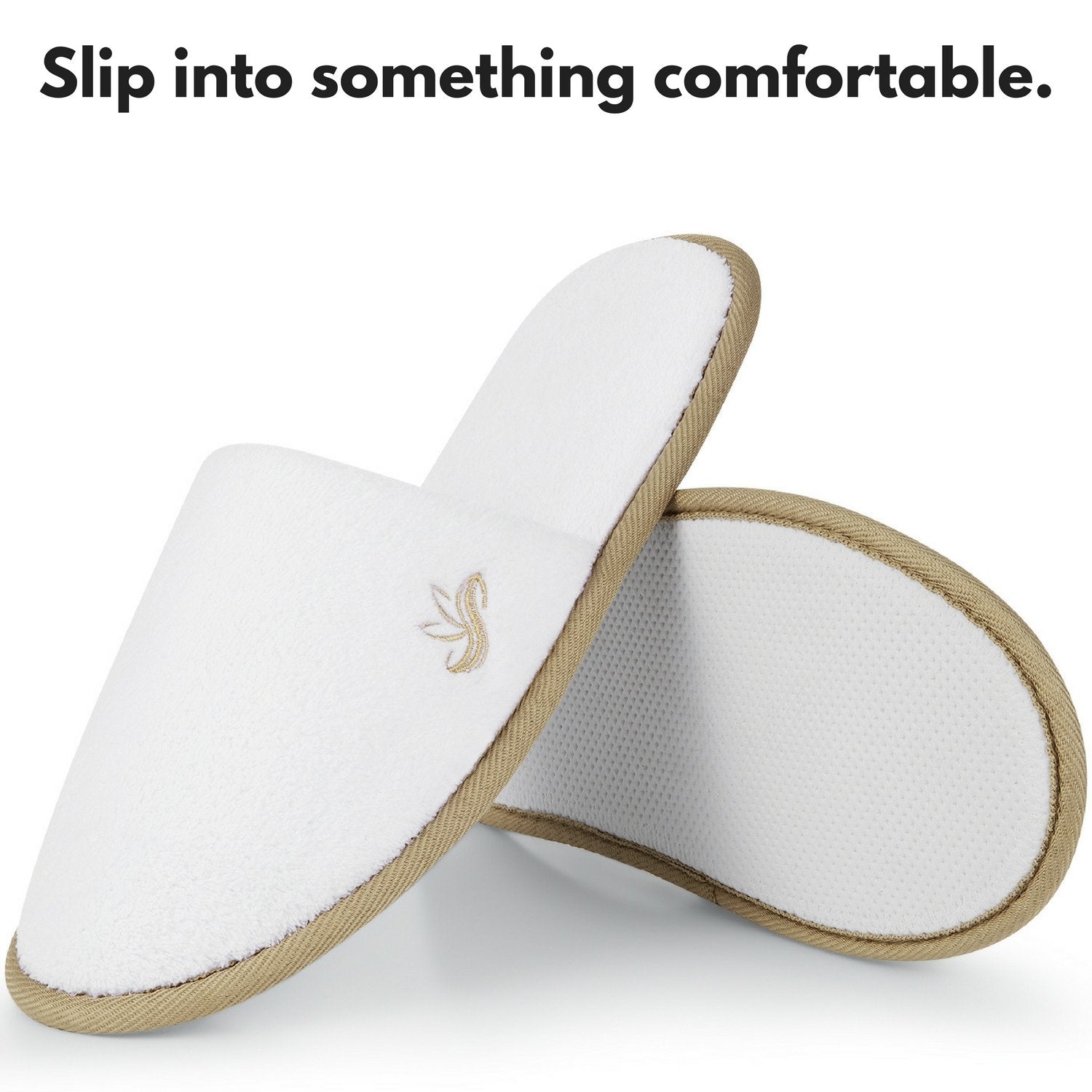 Twelve pairs of individually wrapped white closed toe hotel slippers displayed together