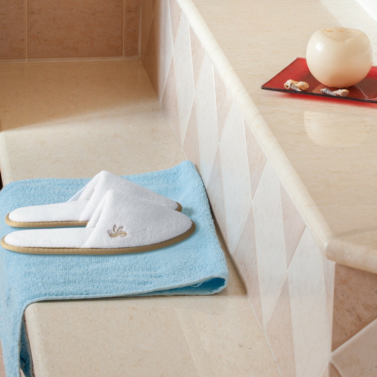 Medium and large sizes of the white premium indoor slippers showing embroidered emblem details
