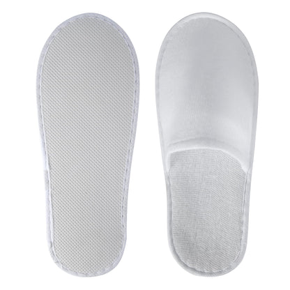 Top down view of UrbanRoots white hotel and guest slippers