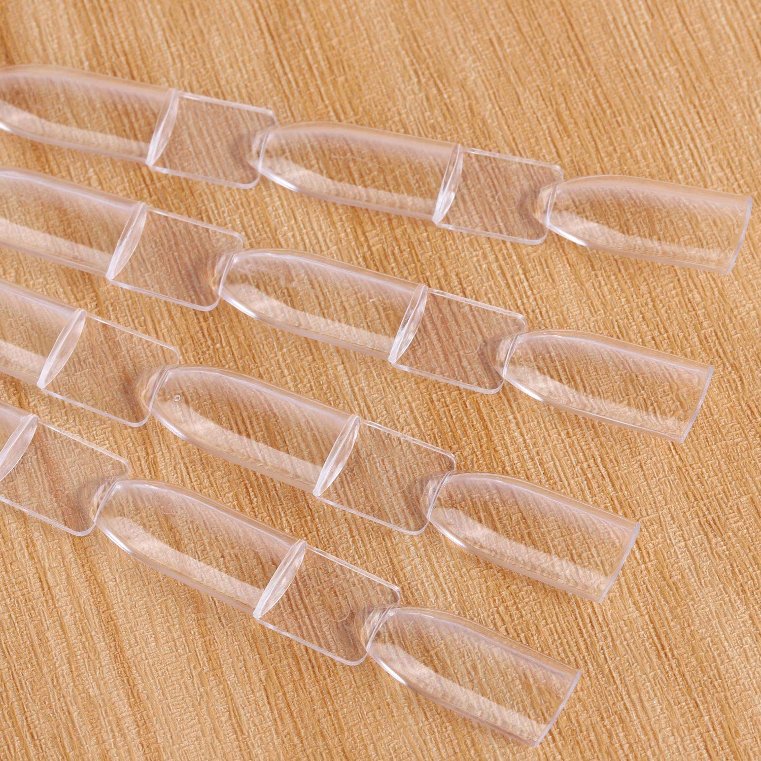 Collection of clear plastic nail tips on metal split ring