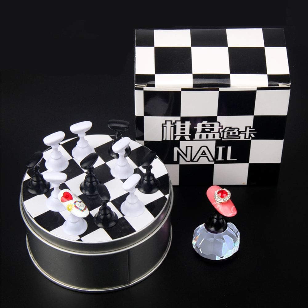 Hand holding the crystal nail art display base while painting a nail tip.