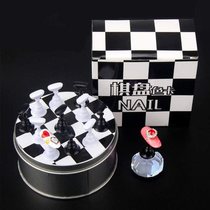 Hand holding the crystal nail art display base while painting a nail tip.