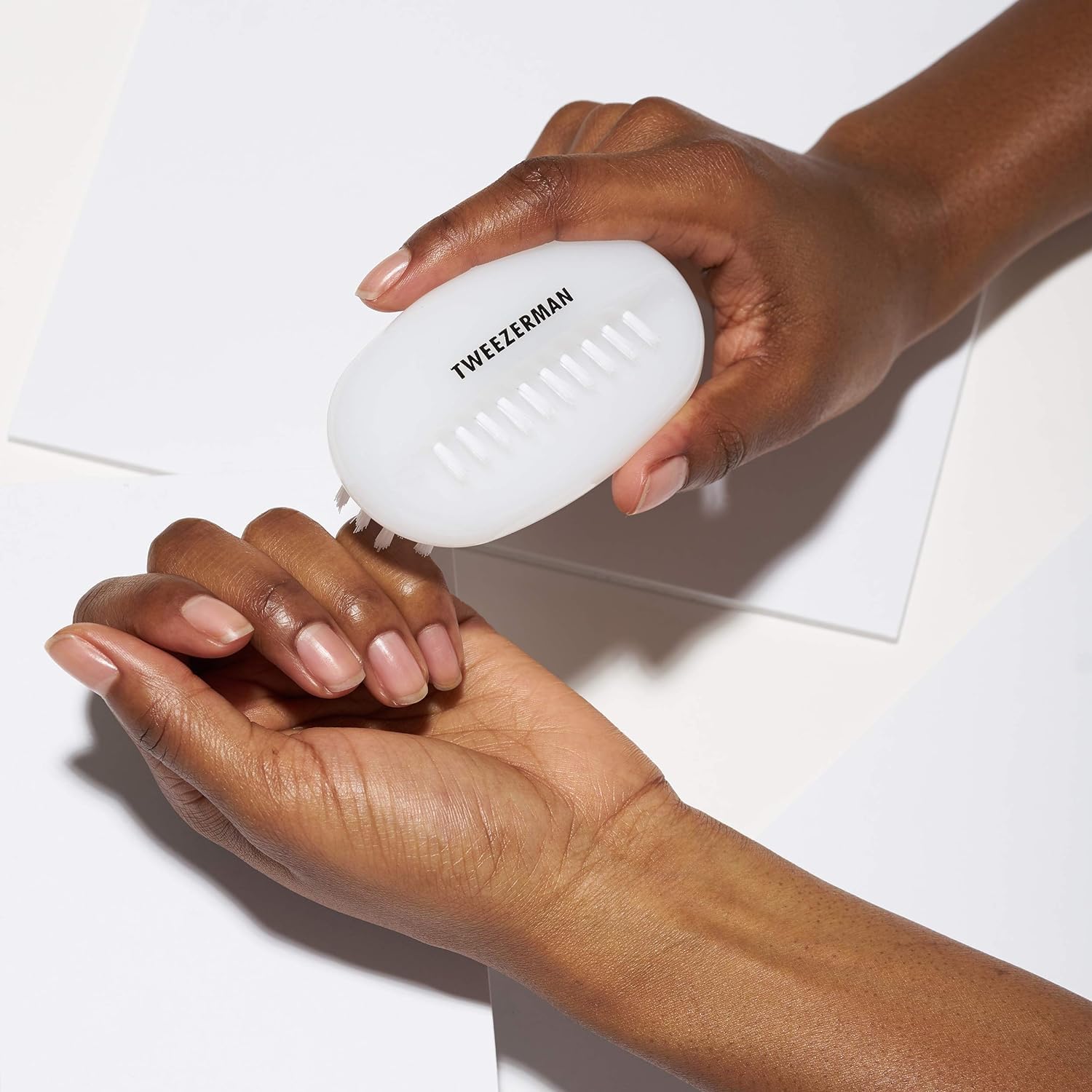 Using Tweezerman brush to clean under nails