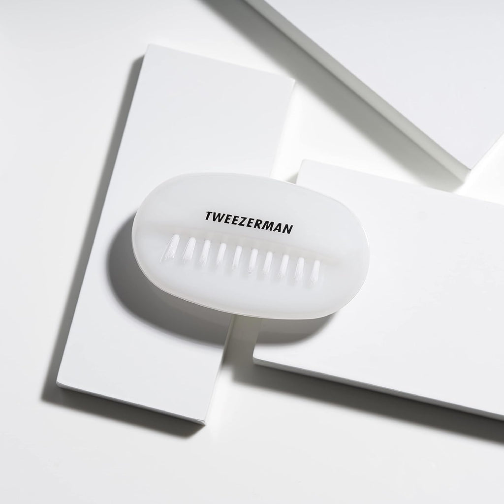 Tweezerman Dual Surface Nail Brush in hand demonstrating grip and size