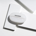Tweezerman Dual Surface Nail Brush in hand demonstrating grip and size