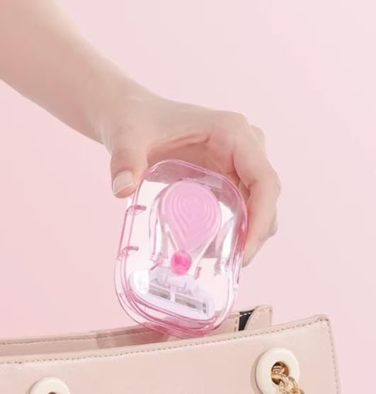 Close up of skin safe blades on a pink travel size womens trimmer