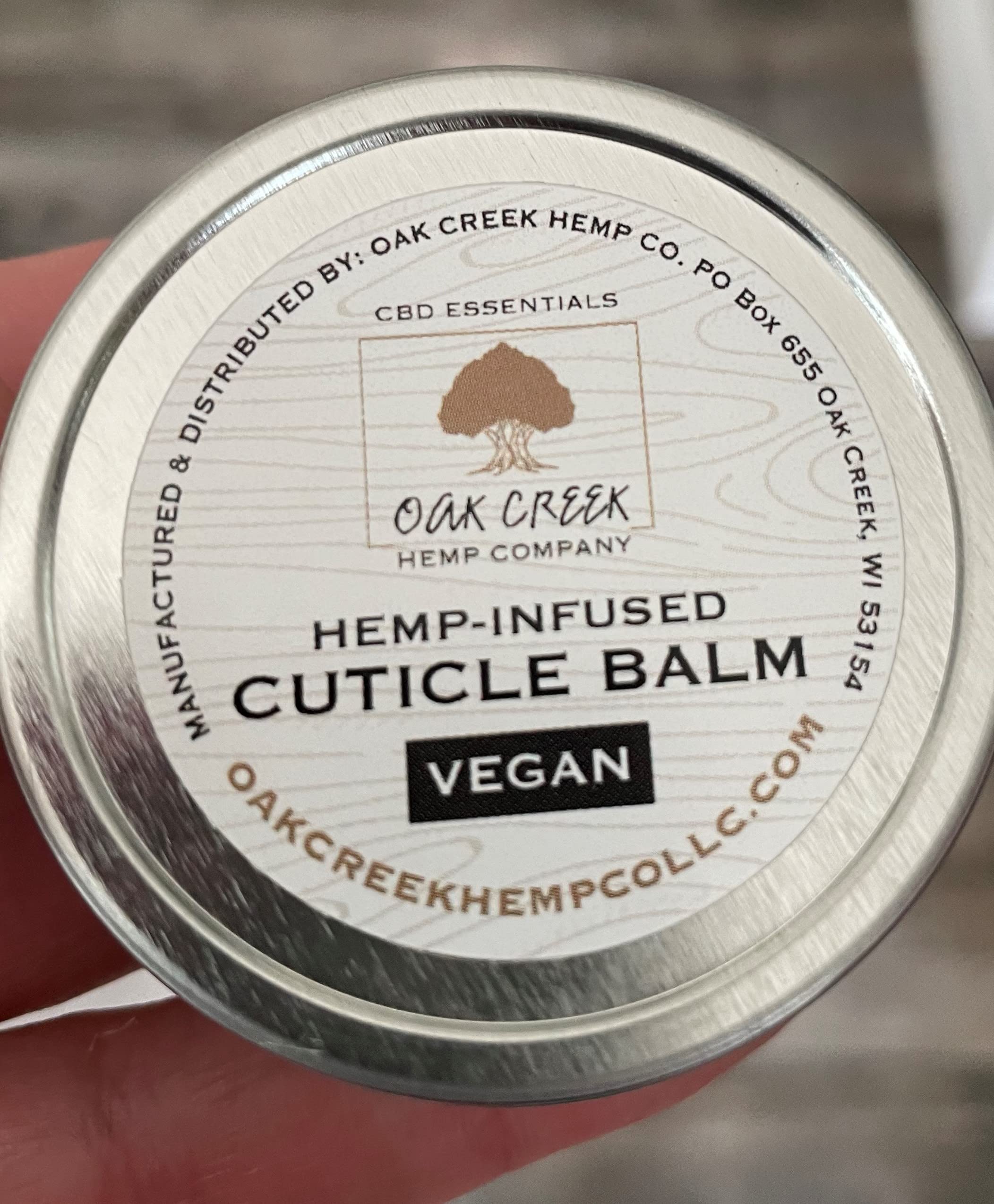 Oak Creek Hemp Company plant-based cuticle balm on wooden background