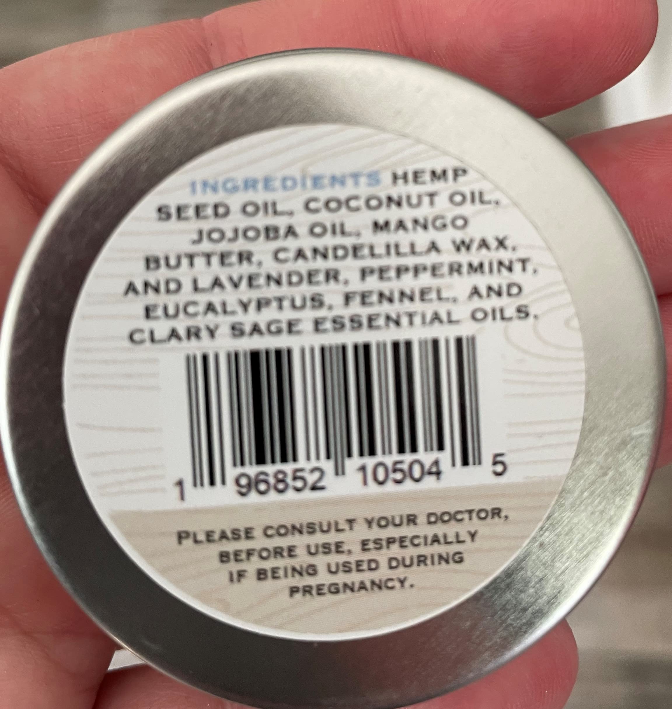 Hand applying Oak Creek Hemp Company natural cuticle repair balm