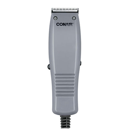 ConairMAN Simple Cut hair clipper kit with four attachment combs and barber accessories spread out on a flat surface.