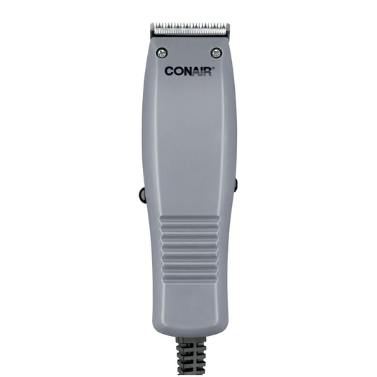ConairMAN Simple Cut hair clipper kit with four attachment combs and barber accessories spread out on a flat surface.