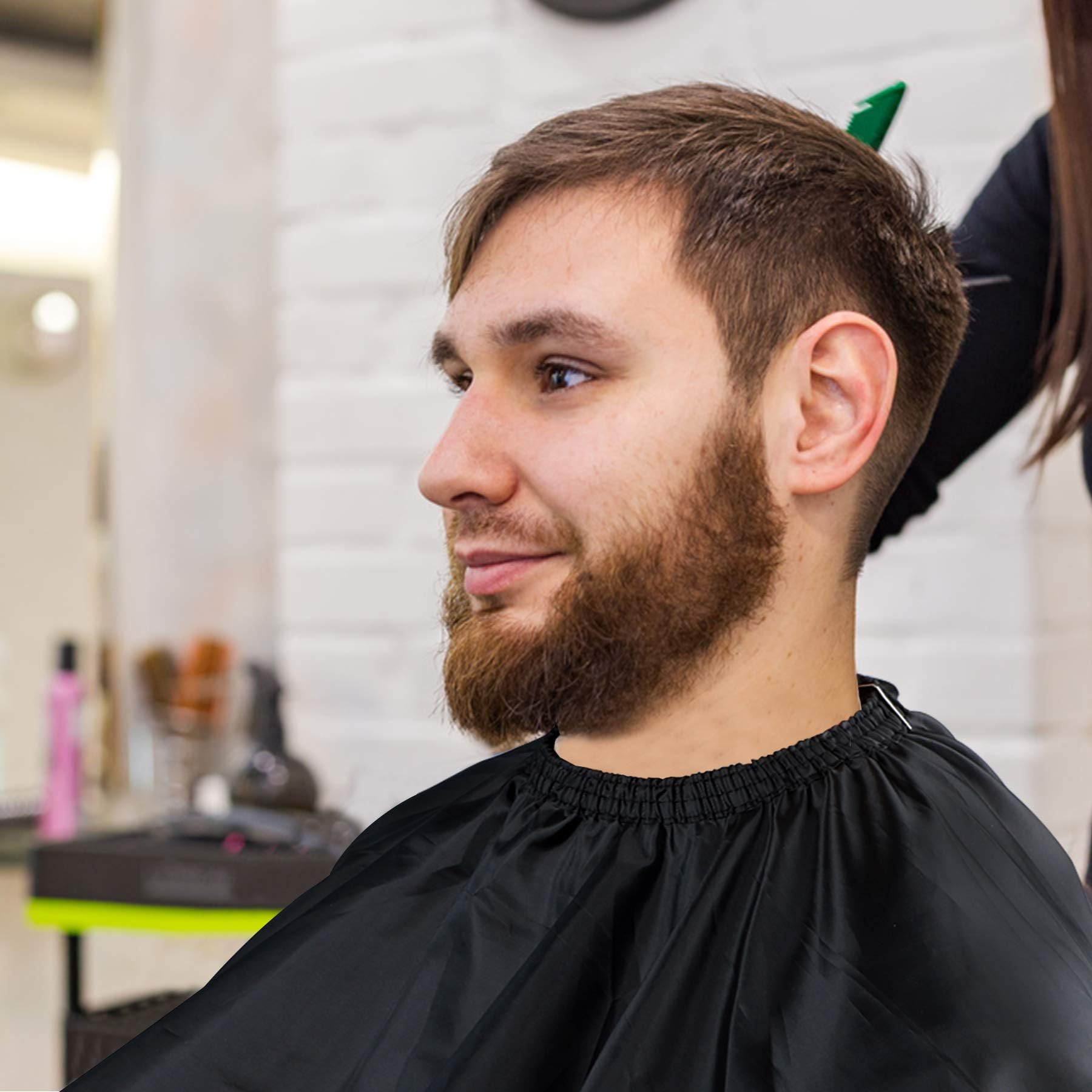 FEBSNOW hairdressing gown being used for an adult haircutting session.