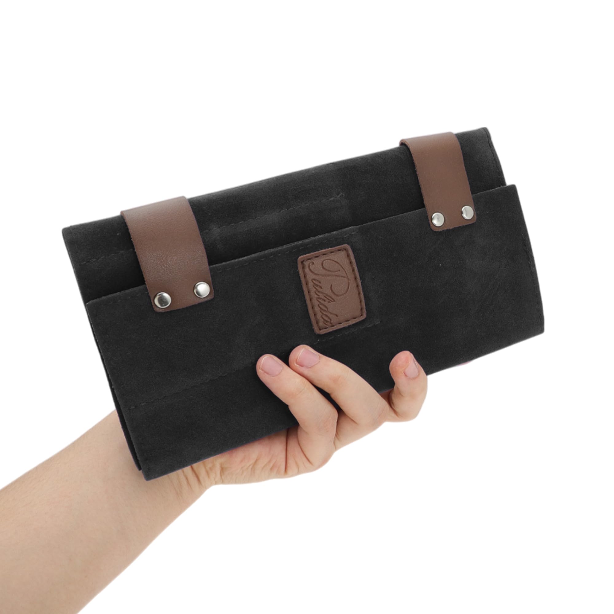 Compact black roll up pouch for hairdressers packed and ready for mobile salon travel.