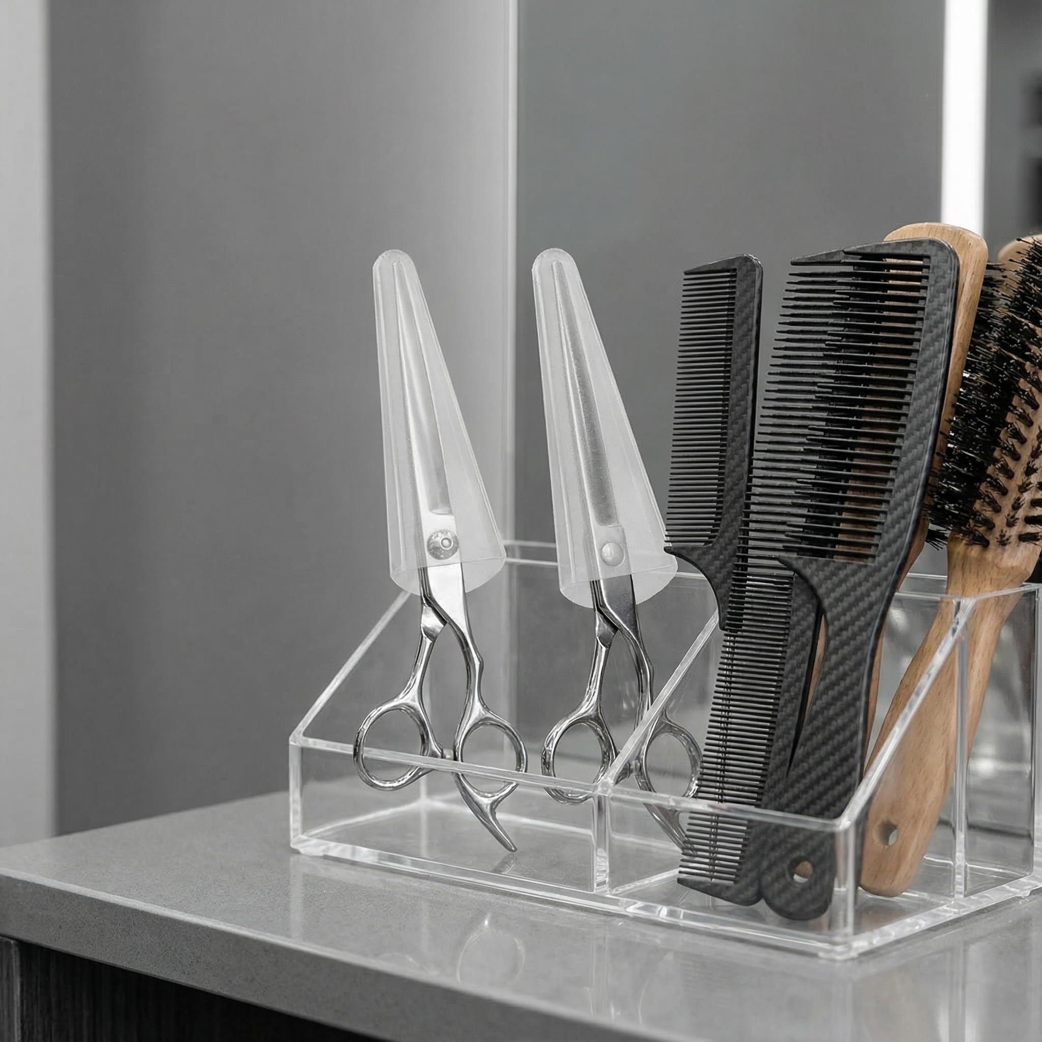 Close up view of Alipis clear PVC scissor tip covers protecting hair cutting shears inside a professional styling setup