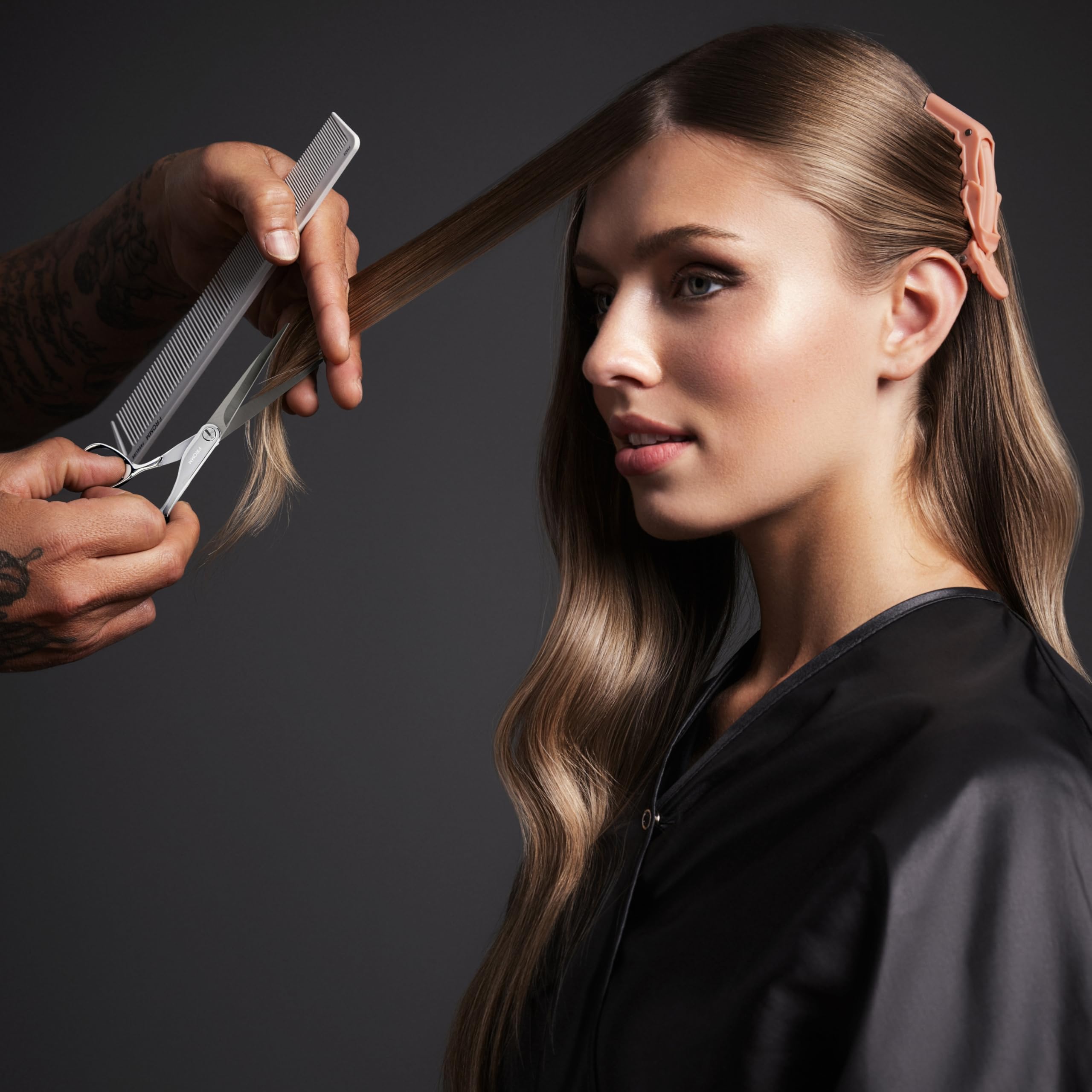 Fromm Explore 5.75 inch hairdresser scissors lying flat on a minimalist salon workspace background