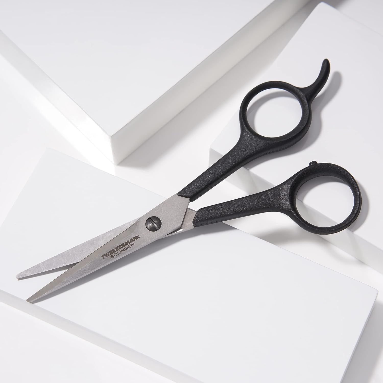 Tweezerman 5.5 inch stainless steel hair shears showcasing the micro-serrated blades.